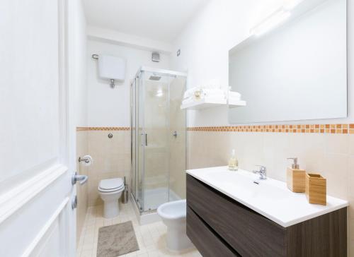 a bathroom with a sink and a toilet and a shower at Le Stanze di Vicolo Bonfigli in Osimo