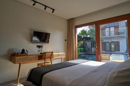 Кровать или кровати в номере Kubu Tropis