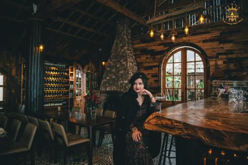 a woman sitting at a bar in a restaurant at Chau Long Sapa 2 Hotel in Sa Pa