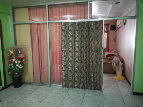 a bathroom with a sliding glass door with a toilet at D-Toys Homestay in Khon Kaen