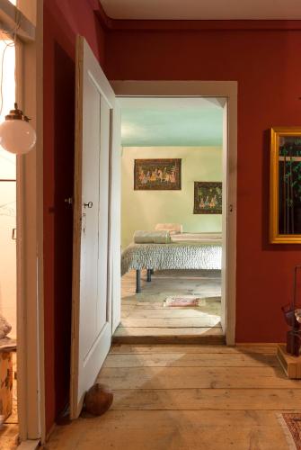 an open door to a room with a bed in a room at La Maisonette in Feltre