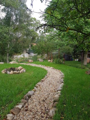 a stone path in a yard with grass and trees at Hejnice Retreat in Hejnice