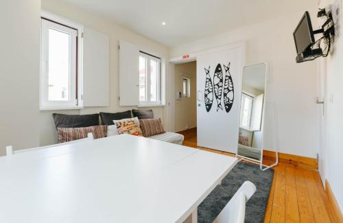 a living room with a white table and a couch at RENT4REST LISBON DOWNTOWN TINY STUDIO Apartments in Lisbon