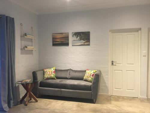 a living room with a couch and a door at Bare Feet Retreat in Scottburgh