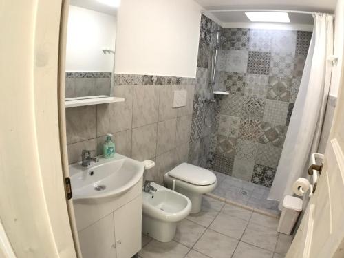 a bathroom with a sink and a toilet and a shower at WHITE POOL 4P Matino - Gallipoli in Matino