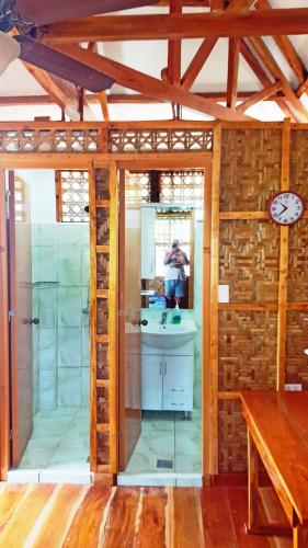a person taking a picture of a bathroom in a house at MJ Room Rental Mahogany in Dauis