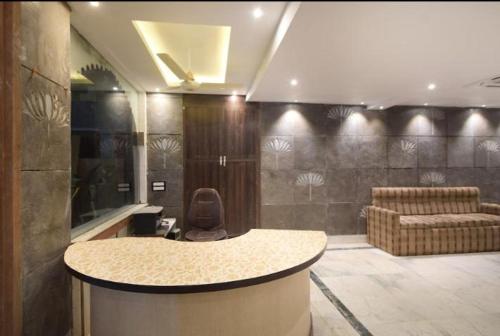 a lobby with a bar with a chair and a couch at Hotel Rani Palace at Lake Fatehsagar in Udaipur
