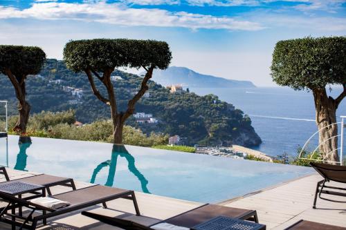 a swimming pool with a view of the ocean at Villa Fiorella Art Hotel in Massa Lubrense
