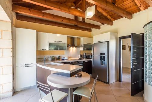a kitchen with a table and chairs in a room at Villa Chara Chania in Agia Marina Nea Kydonias