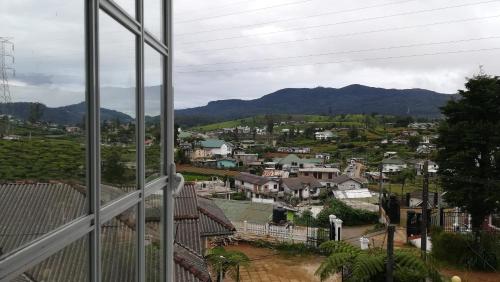 a view of a town from a window at The Fern Inn in Nuwara Eliya