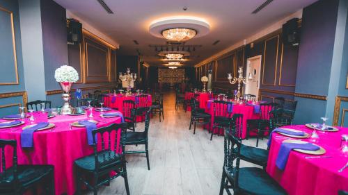 a dining room with pink tables and chairs at No:19 Boutique Hotel in Ankara