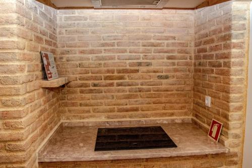 a brick shower with a fireplace in a brick wall at Casa Gil Vicente in Almada
