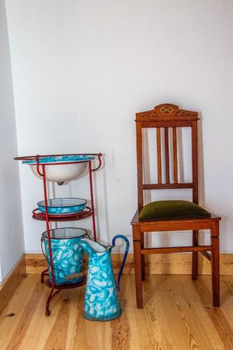 a room with a chair and two vases and a chair at Casa Gil Vicente in Almada