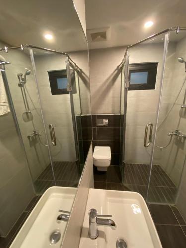 a bathroom with a sink and a shower and a toilet at SPACE Luxury Rental Suites in Rawalpindi