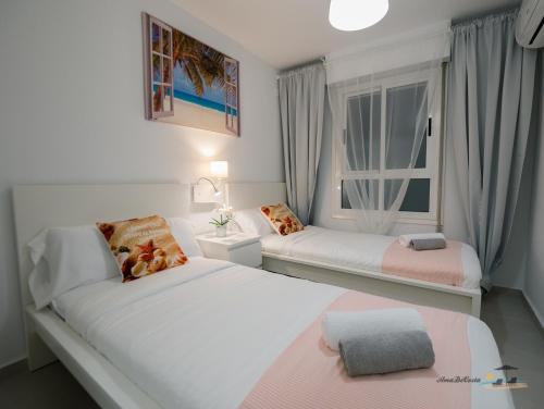 1 Schlafzimmer mit 2 Betten und einem Fenster in der Unterkunft DOS PLAYAS - Torrevieja in Torrevieja