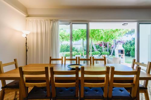 a dining room with a table and chairs and a large window at Villa 715 - our Albufeira holiday retreat in Albufeira
