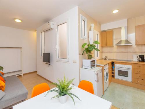 a kitchen and living room with a table and chairs at Apartment Eixample Dret Sagrada Familia by Interhome in Barcelona