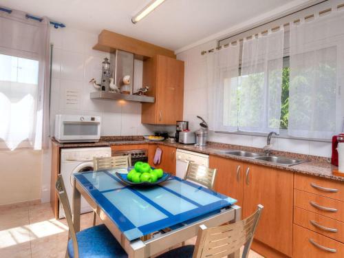 a kitchen with a table with a bowl of fruit on it at Apartment Fane De Baix I by Interhome in Llança