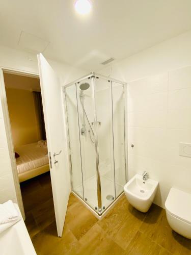 a bathroom with a shower and a toilet and a sink at Verona Enjoy in Verona
