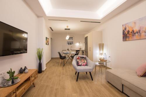a living room with a couch and a tv at B4B Sea n' City in Zakynthos Town
