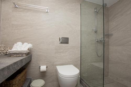 a bathroom with a toilet and a glass shower at B4B Sea n' City in Zakynthos Town
