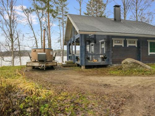 a small house with a porch and a truck in front of it at Holiday Home Varpu by Interhome in Hauho