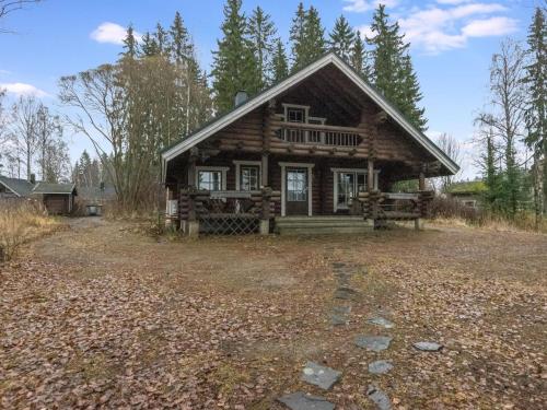 a log cabin in the middle of a forest at Holiday Home Kärkimökki by Interhome in Hauho