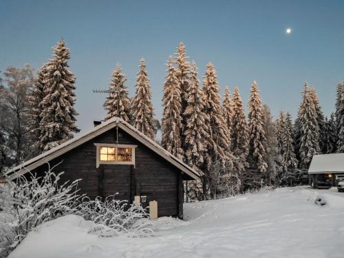 a small cabin in the snow with trees at Holiday Home Puolukka by Interhome in Hauho