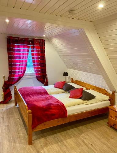 a bedroom with a large bed in a attic at Landgasthaus Alter Posthof in Halsenbach