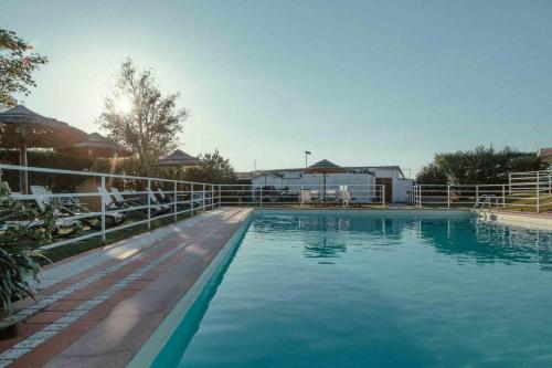 a large swimming pool with a fence around it at Appartamento Nonno Trulli in Stabbia