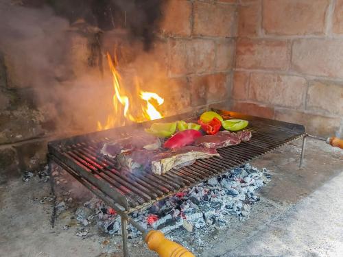 a grill with some meat and vegetables on it at Holiday Home Anđela by Interhome in Dobrinj