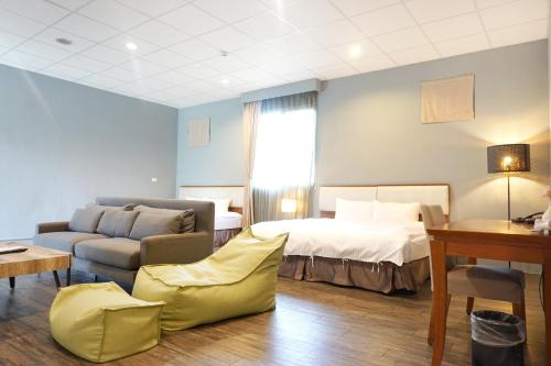 Postel nebo postele na pokoji v ubytování NCNU Campus Inn暨大行旅