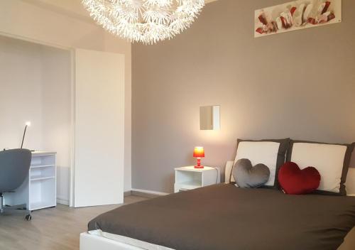 a bedroom with a bed with two hearts on it at SWEETHOME DIJON - Drapeau in Dijon