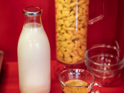 a bottle of milk on a table with a bowl of food at hotelF1 Chambéry Nord Rénové in Chambéry