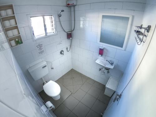 an overhead view of a bathroom with a toilet and sink at Florentine Backpackers Hostel - ages 18-55 in Tel Aviv