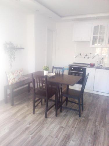 a kitchen with a table and chairs in a room at Rozinka apartman in Dunaújváros