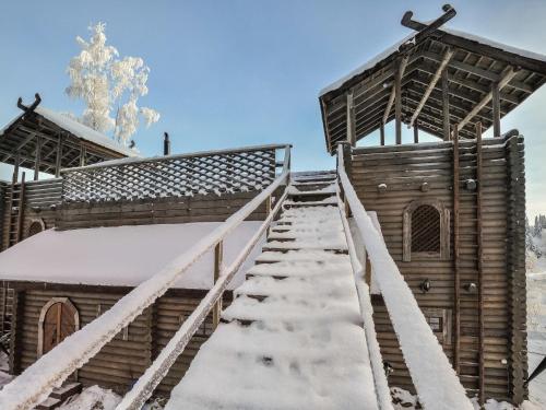 a staircase leading up to a church in the snow at Holiday Home Härkälinna by Interhome in Hauho