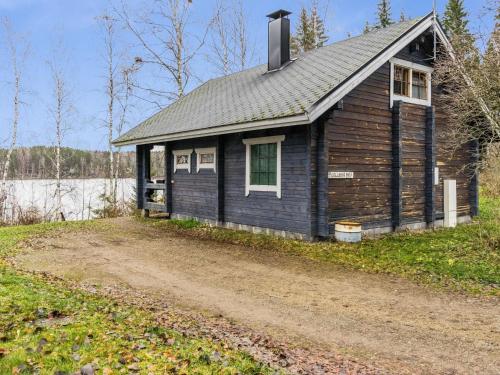 a small house on the side of a dirt road at Holiday Home Puolukka by Interhome in Hauho