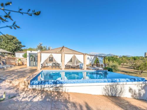a villa with a swimming pool and a house at Holiday Home Can Bernat by Interhome in Biniamar