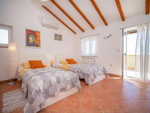 a bedroom with two beds and a large window at Holiday Home Mila by Interhome in Kras