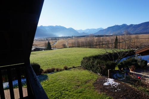 a view from a balcony of a field and mountains at Ferienwohnung Murnauer Moos in Murnau am Staffelsee