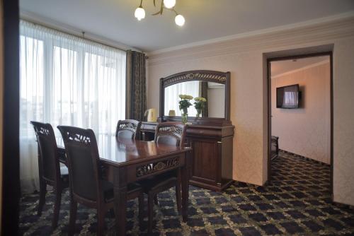 a hotel room with a table and a mirror at Hotel Mir in Rivne