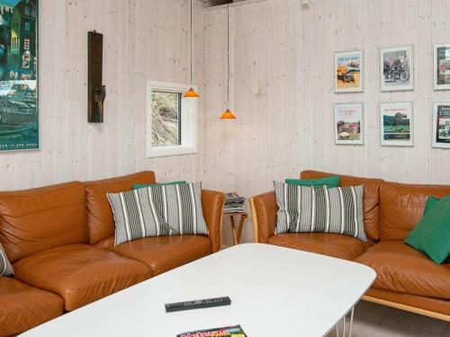 a living room with two couches and a table at 8 person holiday home in Glesborg in Glesborg