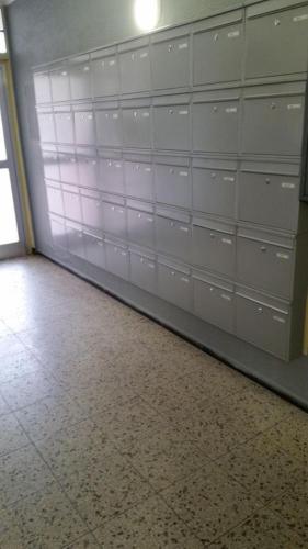 a garage with white garage doors and a tile floor at Ferienwohnungen Fuchs in Duisburg