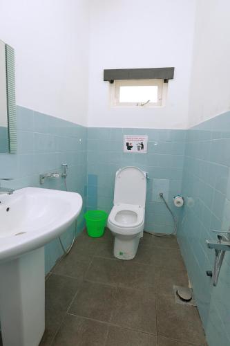 a blue bathroom with a toilet and a sink at Sapu's Mountain breeze Nuwara Eliya in Nuwara Eliya