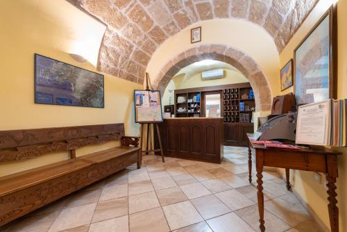 a tasting room with an archway and a bookstore at San Francesco Heritage Hotel in Alghero