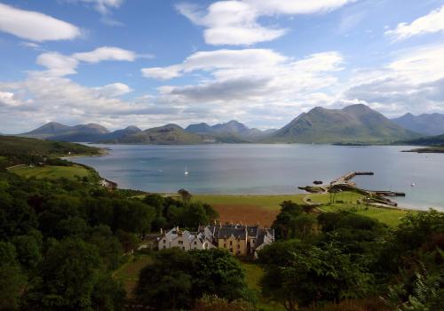 
a large body of water with a mountain range at Raasay House Hotel in Raasay
