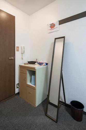 a bathroom with a mirror next to a counter at Cozy house 202, free wifi a rented electric bicycle in Kyoto