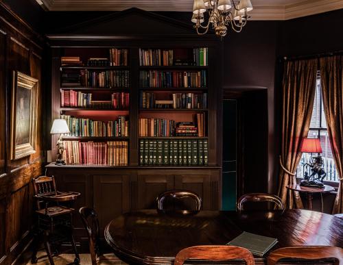 a living room filled with furniture and a bookshelf at The Rookery in London