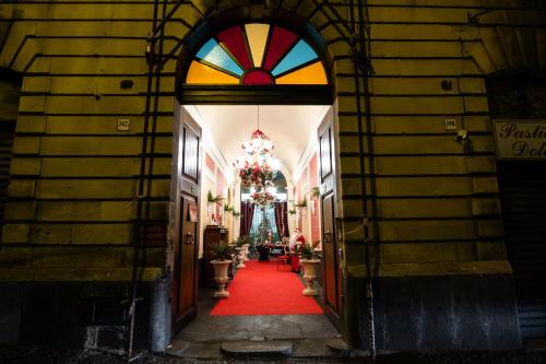 a hallway with a red carpet and a christmas tree at Raciti Palace in Acireale